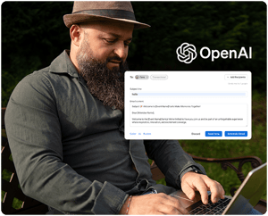 Skægget mand med hat skriver på bærbar computer udendørs, OpenAI-logo og e-mail-interface overlejret.